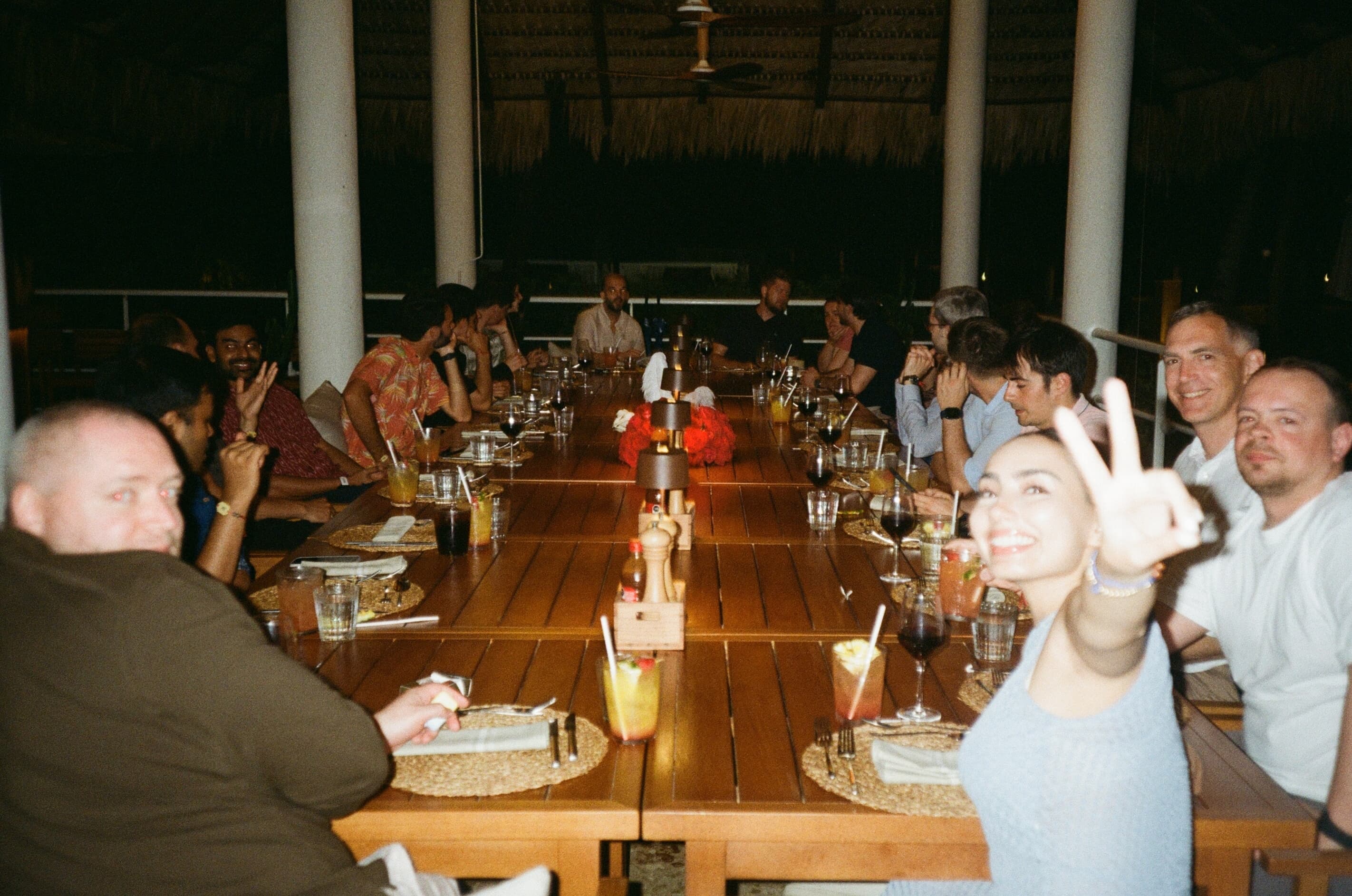 Another angle of the MUI team sitting around a large rectangular table for dinner.